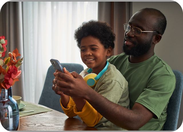 Father and child using phone together